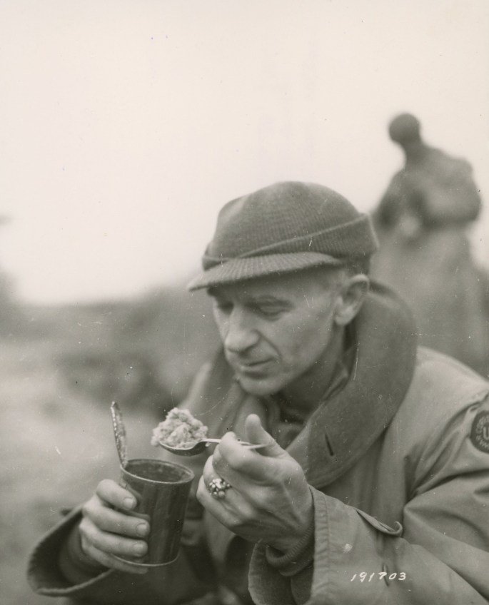 Ernie Pyle eating C rations Anzio Beachhead area Italy March 18 1944